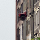 Illustration for article titled Dang Detroit Kids Push Abandoned Dump Truck Out Packard Plant Window